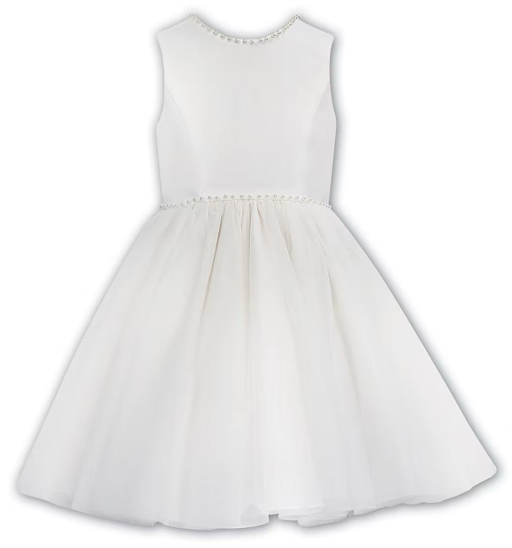 Sarah Louise Ivory Pearl Ballerina Dress featuring a soft peach tone, pearl-trimmed neckline, full layered tulle skirt and statement V-back bow.