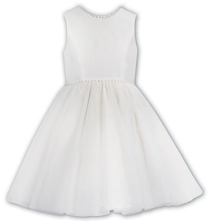 Sarah Louise Ivory Pearl Ballerina Dress featuring a soft peach tone, pearl-trimmed neckline, full layered tulle skirt and statement V-back bow.