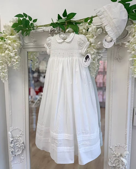 Sarah Louise Philippa Christening Gown & Bonnet featuring hand-smocked floral embroidery, pearl details, scalloped trims and a matching bonnet.