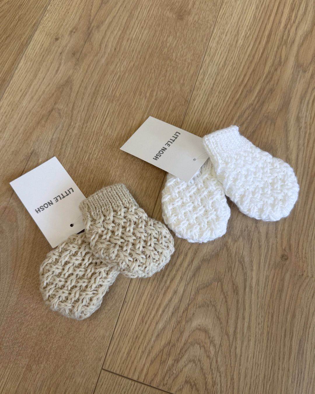 Little Nosh Curly Knit baby mittens in basketweave knit with ribbed cuffs, available in white and biscuit brown.
