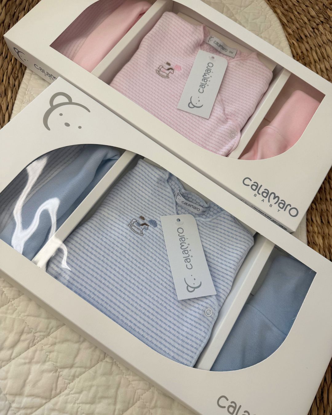 Calamaro Rocking Horse newborn baby gift set in pink and blue, featuring a striped wrap bodysuit with embroidered rocking horse, matching footed trousers and coordinating hat.