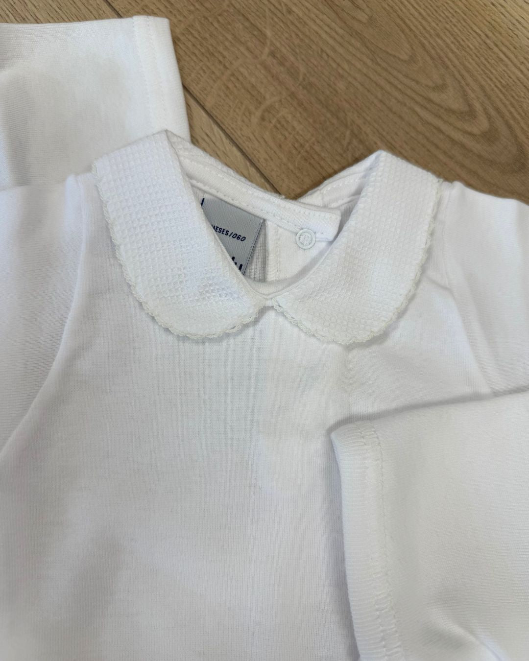 Babidu white unisex baby bodysuit with Peter Pan collar and coloured stitch trim.
