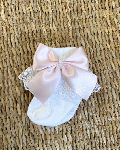 Crafted in soft white fabric, each pair features a delicate lace frill trim, finished with a pretty satin side bow and elegant pearl chain centre.