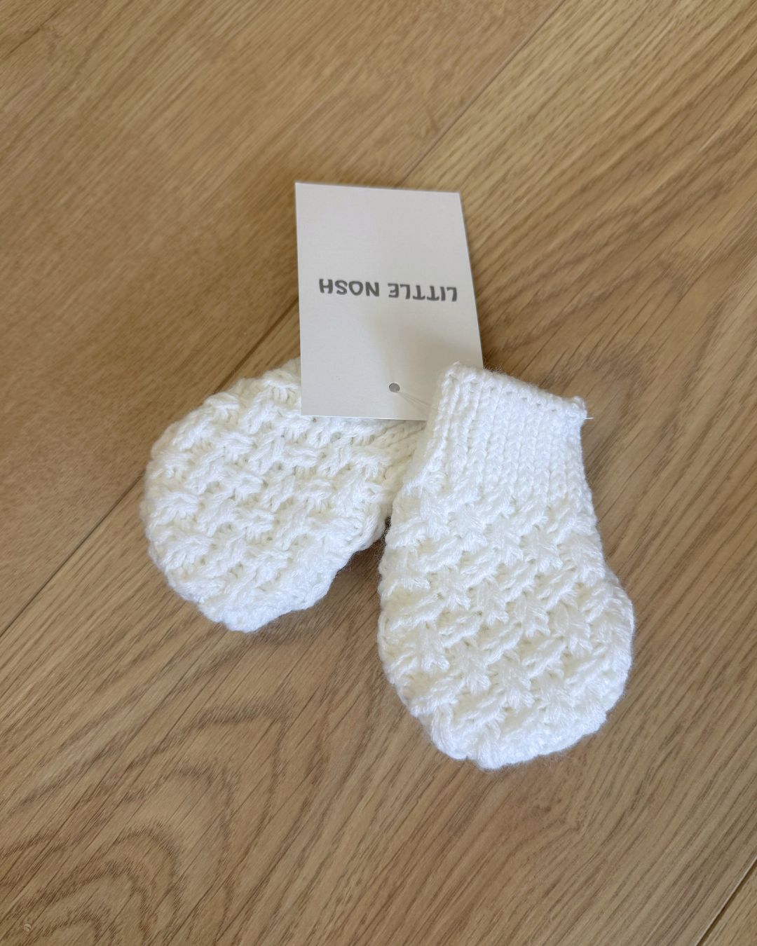 Little Nosh Curly Knit baby mittens in basketweave knit with ribbed cuffs, available in white and biscuit brown.
