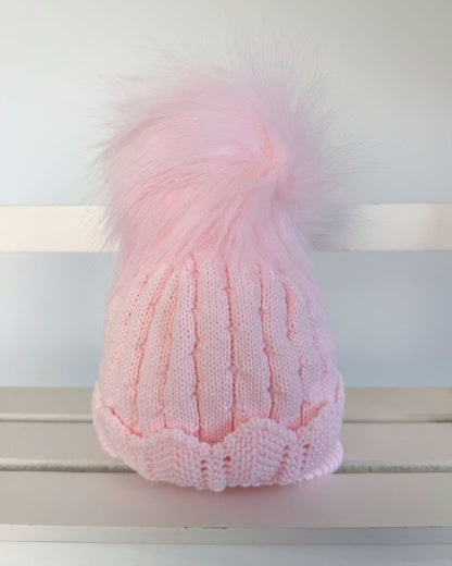 Little Nosh Aurora pink knitted baby girls winter hat with faux fur pom pom, scalloped hem and cosy ear covers.