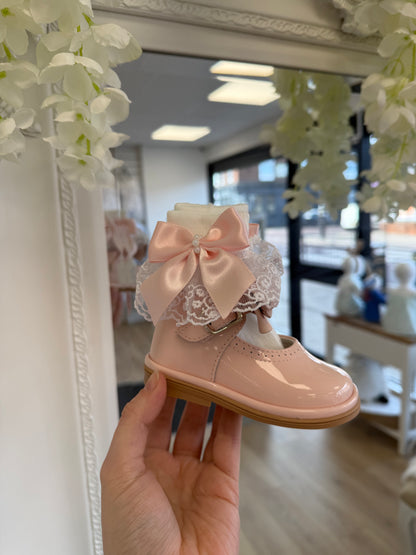 Crafted in soft white fabric, each pair features a delicate lace frill trim, finished with a pretty satin side bow and elegant pearl chain centre.
