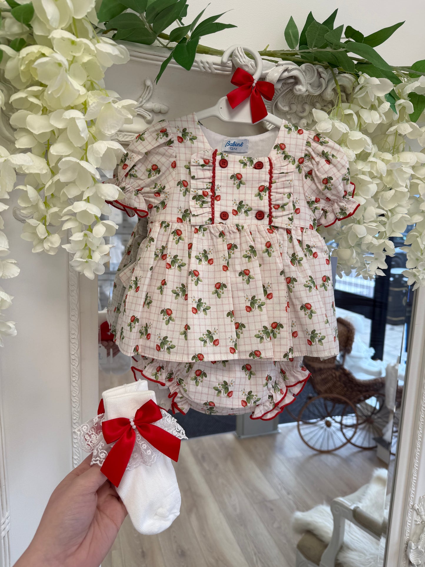 Crafted in soft white fabric, each pair features a delicate lace frill trim, finished with a pretty satin side bow and elegant pearl chain centre.