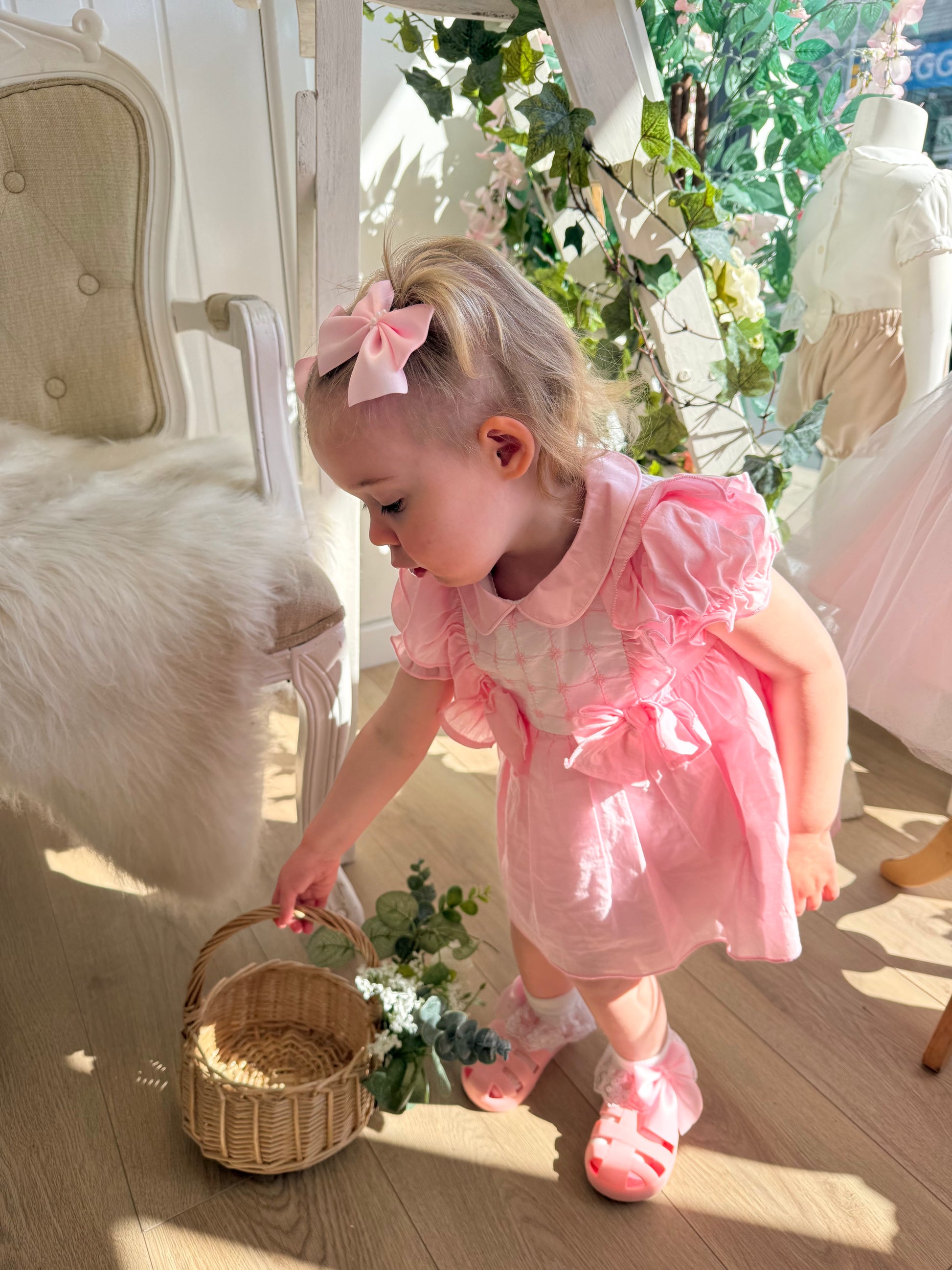 A soft rosy pink, this traditional Spanish-style dress is paired with matching jam pants. Adorned with a white chest panel featuring subtle stitch detailing, the dress is finished with pretty shoulder frills, two bow accents and a classic Peter Pan collar.