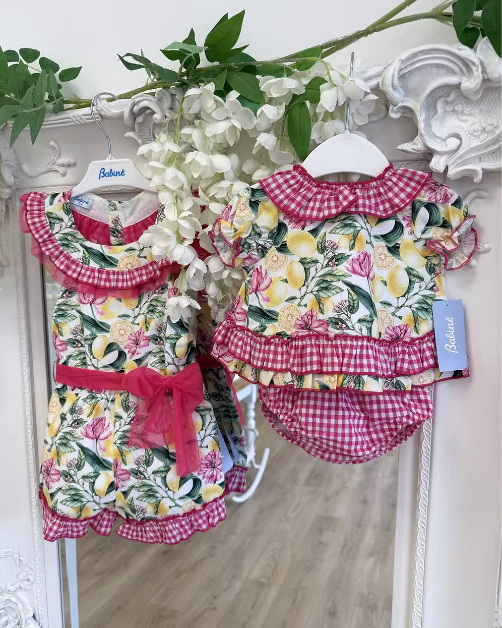 Babine Lemon Blossom Swing Back Dress & Pants featuring a lemon and pink floral print, open swing back, large tulle bow, frill collar, and matching pink gingham pants.