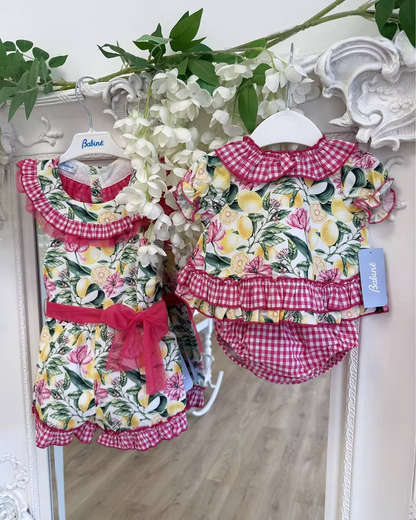 Babine Lemon Blossom Swing Back Dress & Pants featuring a lemon and pink floral print, open swing back, large tulle bow, frill collar, and matching pink gingham pants.