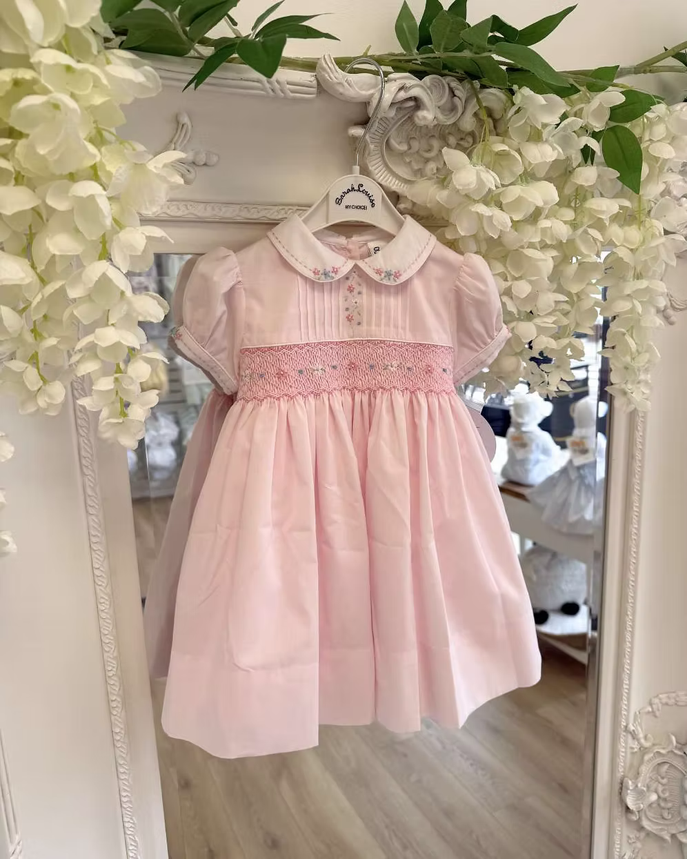 Sarah Louise Blair Pink Smock Dress featuring hand-smocked embroidery, pintuck detailing, embroidered Peter Pan collar, full skirt and bow back.