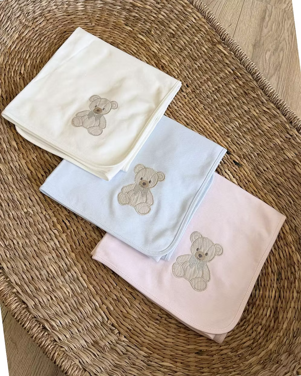 Baby Gi Teddy Shawl featuring soft cotton fabric, embroidered teddy bear detail and available in ivory, pink and blue colourways.