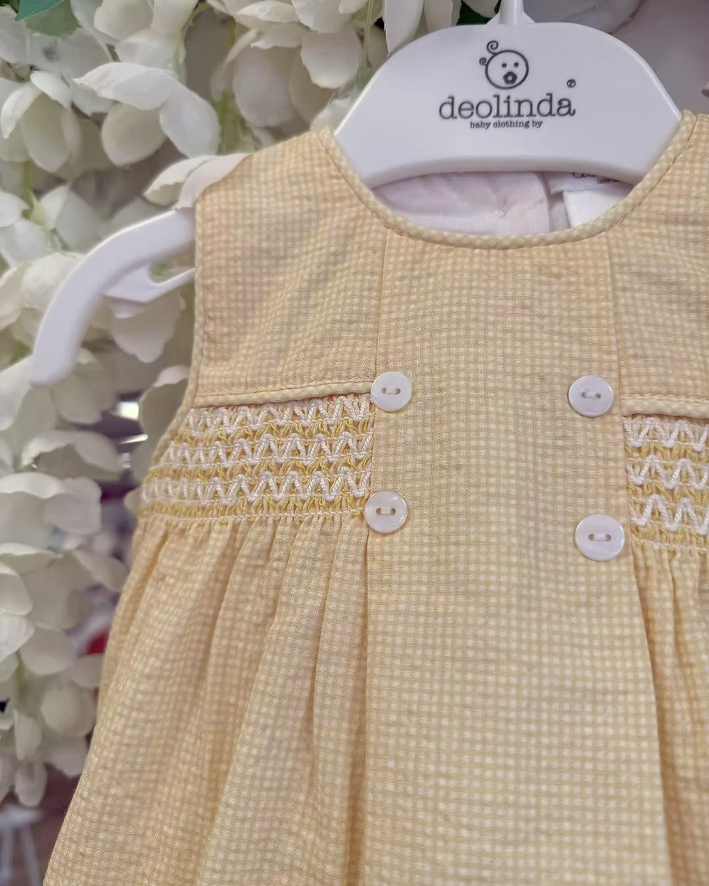 Deolinda Bumble Romper featuring buttery yellow gingham, a smocked chest panel, pleat detailing, button accents and a classic unisex design.