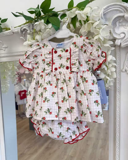 Off-white and pink check baby dress with strawberry print, frill chest detail, puff sleeves, red stitch trims, matching pants, and bow back fastening.
