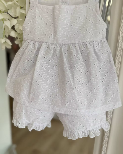 white broderie anglaise floaty top with matching frill trim shorts and shoulder ties