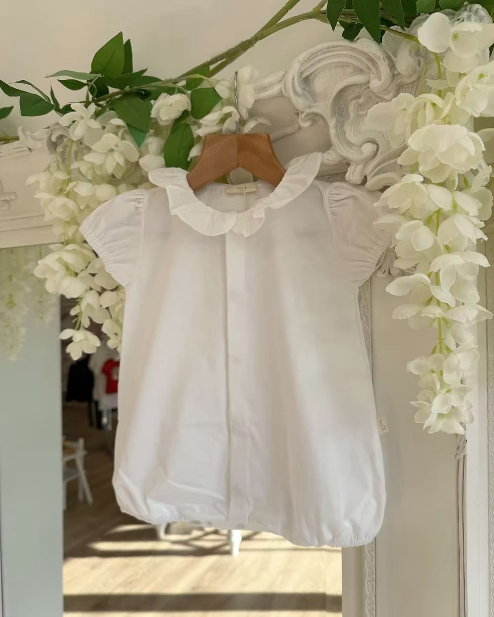 Baby Gi Butterfly Back Romper featuring a white bubble design, oversized butterfly back detail, pink embroidered trims and a frill collar.