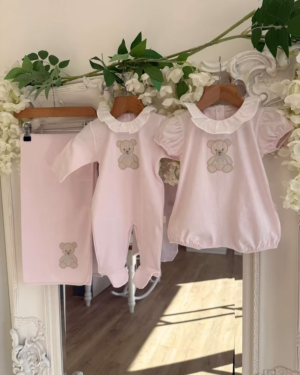 Baby Gi Teddy Shawl featuring soft cotton fabric, embroidered teddy bear detail and available in ivory, pink and blue colourways. Along side matching babygrow and romper.