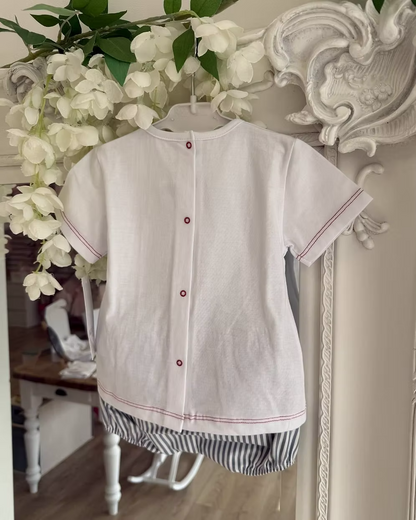 Featuring soft navy striped shorts paired with a fresh white tee. Beautifully detailed with subtle red stitch trims and a chest pocket finished with a navy stripe flap and wooden button. red back popper fastening.