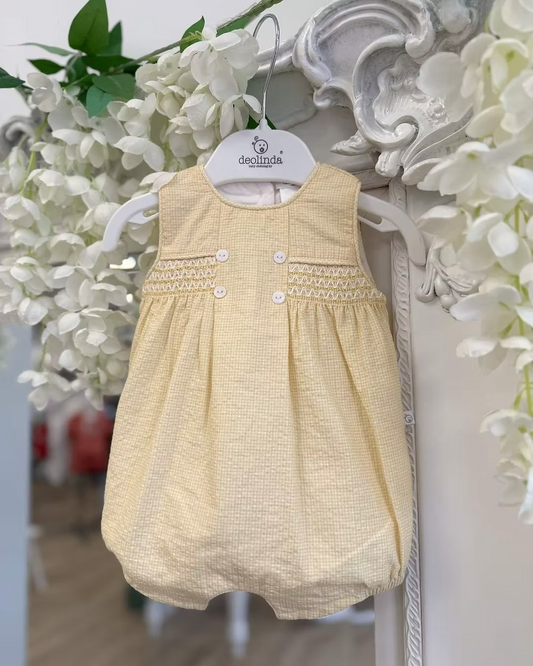 Deolinda Bumble Romper featuring buttery yellow gingham, a smocked chest panel, pleat detailing, button accents and a classic unisex design.