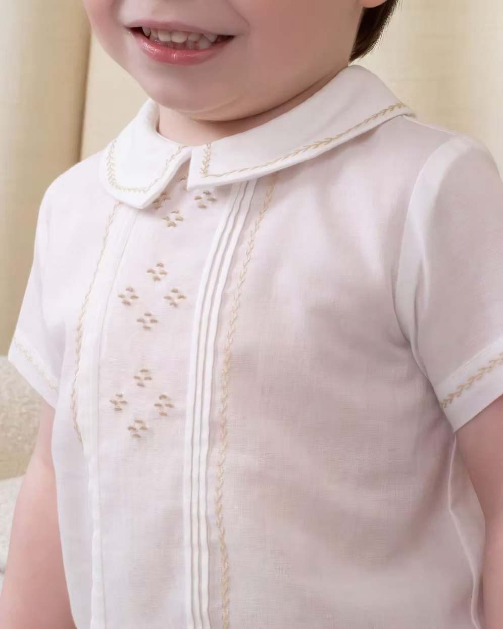 Sarah Louise x Little Lambs Heritage Boys Short Set featuring an ivory shirt with traditional detailing and tailored beige shorts.