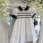 White dress with navy collar and trim nd full smocked chest