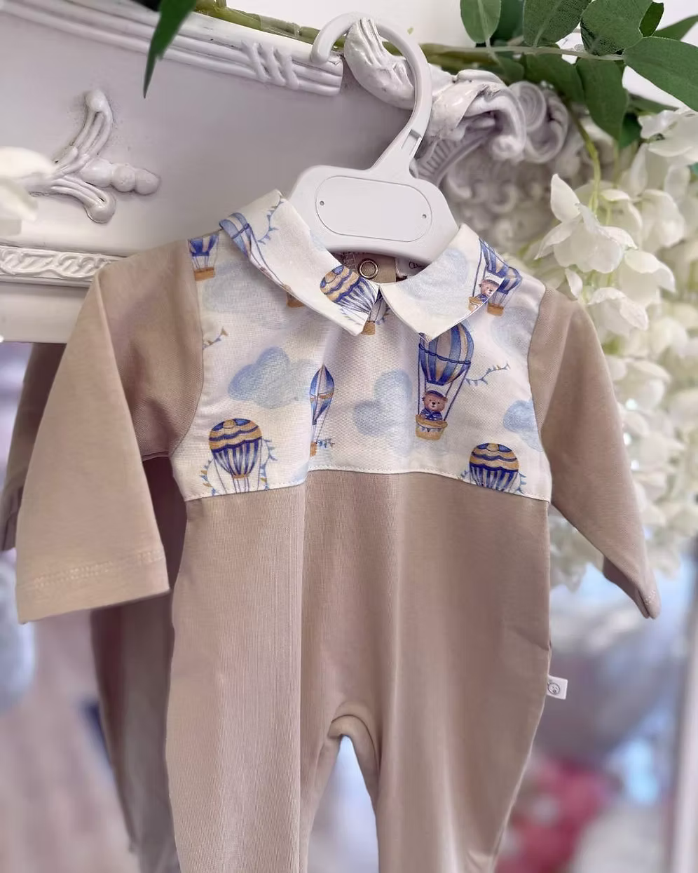 Deolinda Air Balloon Babygrow featuring a hot air balloon and bear print, neutral lower half, Peter Pan collar and popper fastening.