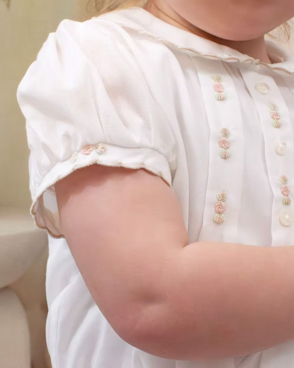 Sarah Louise x Little Lambs Heritage Girls Short Set featuring an ivory hand-smocked blouse with peach embroidery and neutral tailored shorts.