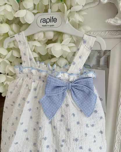 Blue Flower Romper. Designed in a soft white crinkle-textured fabric, this delicate piece is adorned with dainty blue floral detailing