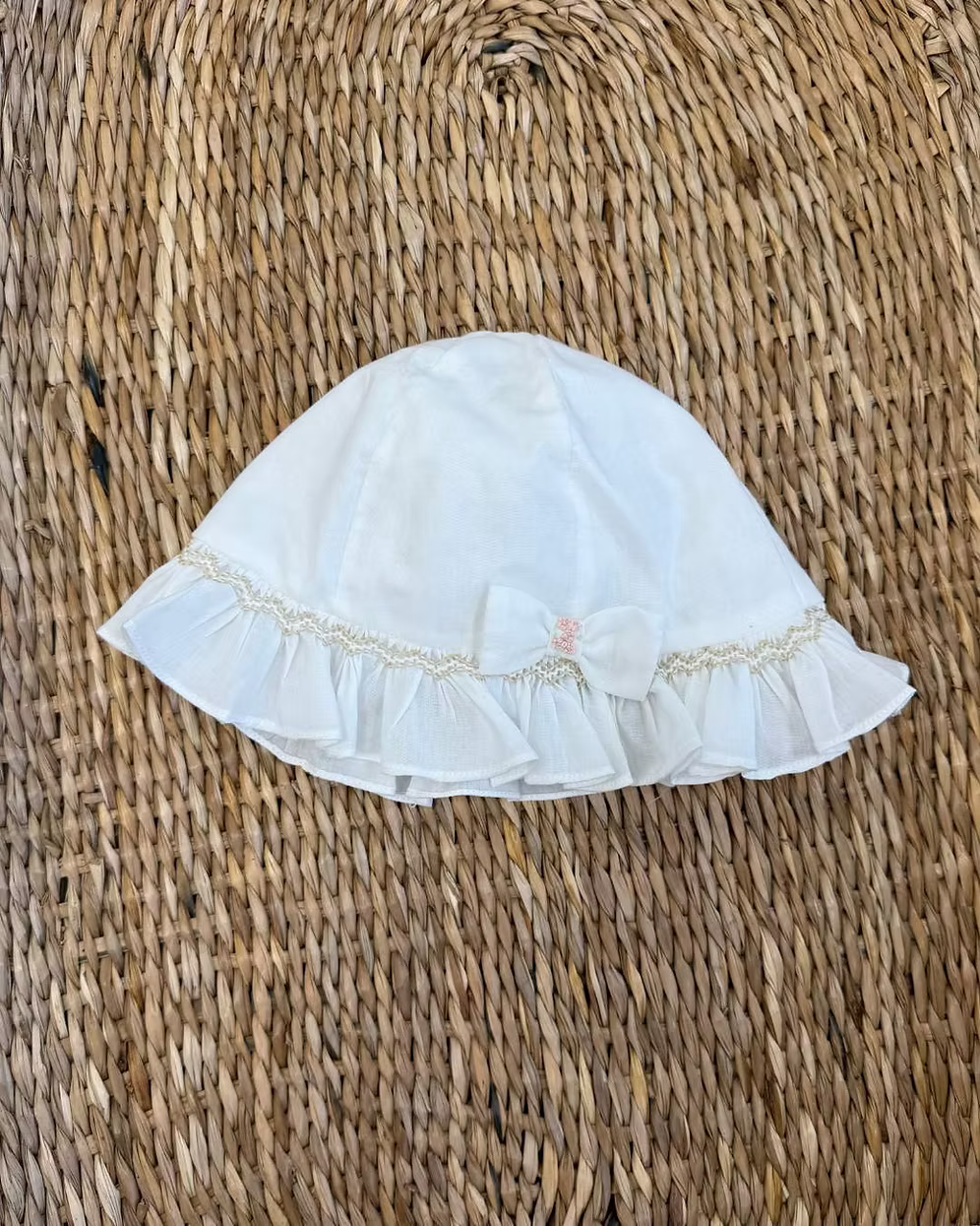Sarah Louise x Little Lambs Heritage Ruffle Hat featuring soft ivory fabric, delicate ruffle trim and subtle embroidered detailing.