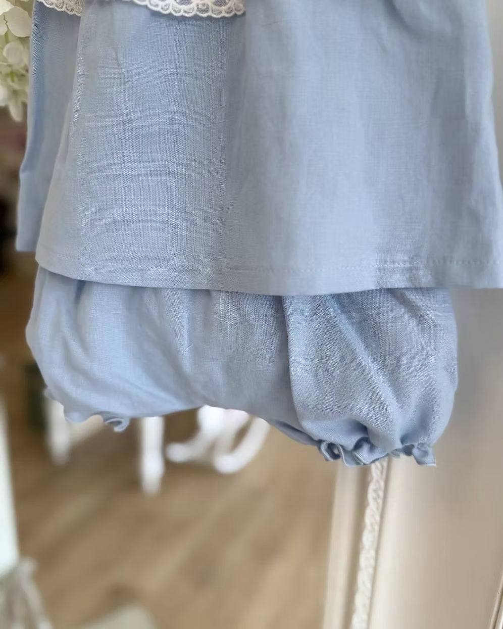blue top and short with a white chest and white lace trim