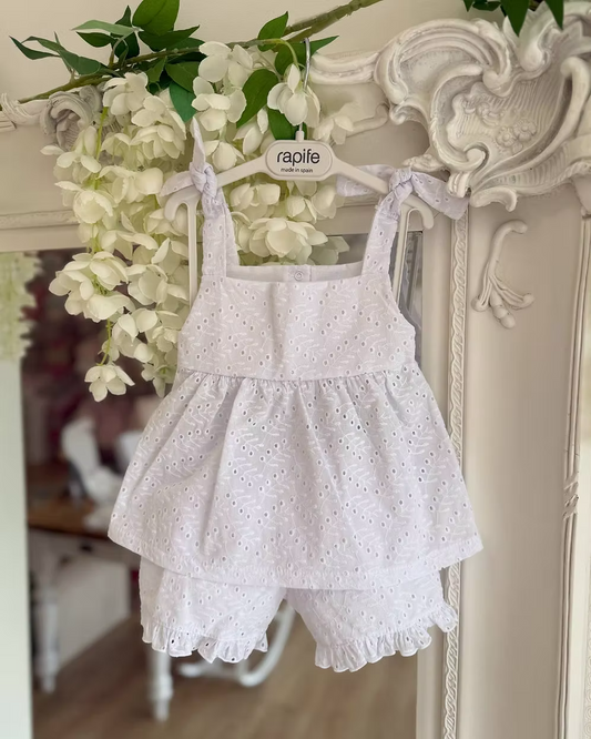white broderie anglaise floaty top with matching frill trim shorts and shoulder ties
