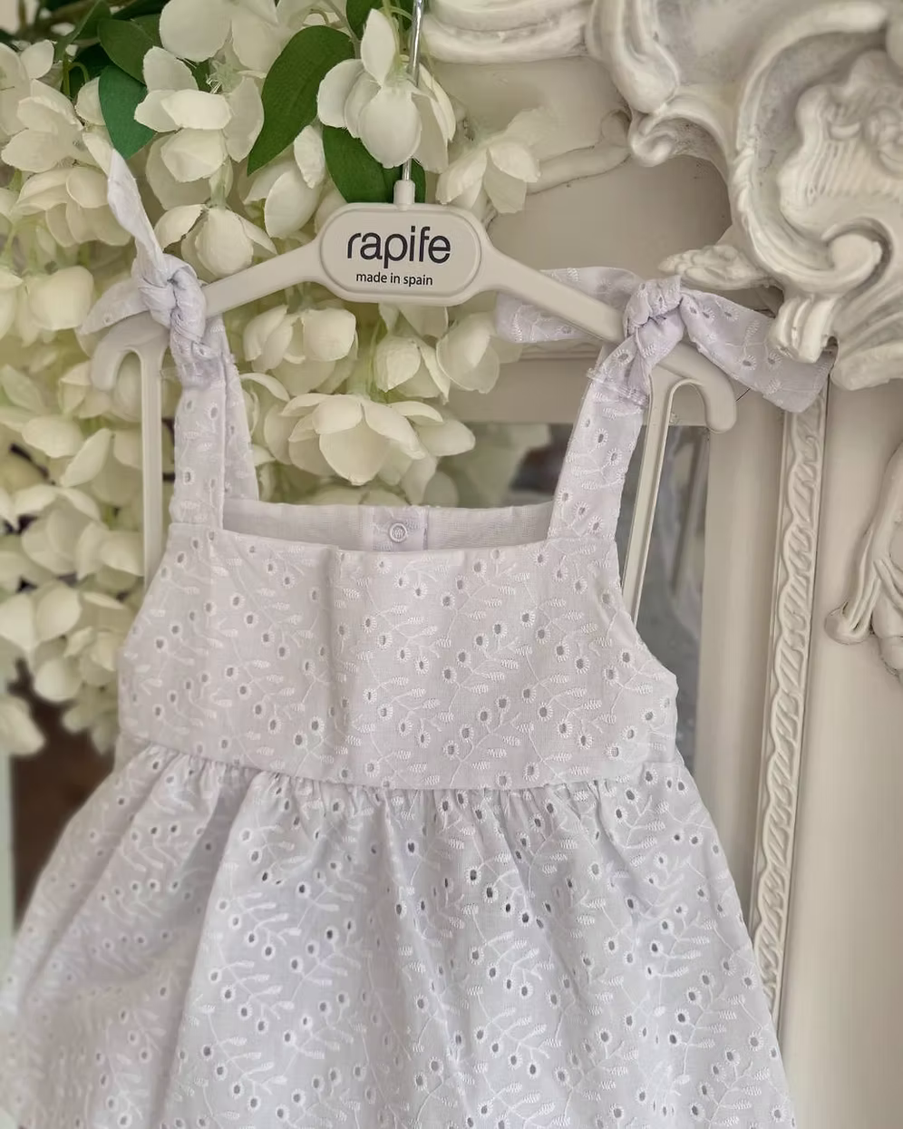 white broderie anglaise floaty top with matching frill trim shorts and shoulder ties