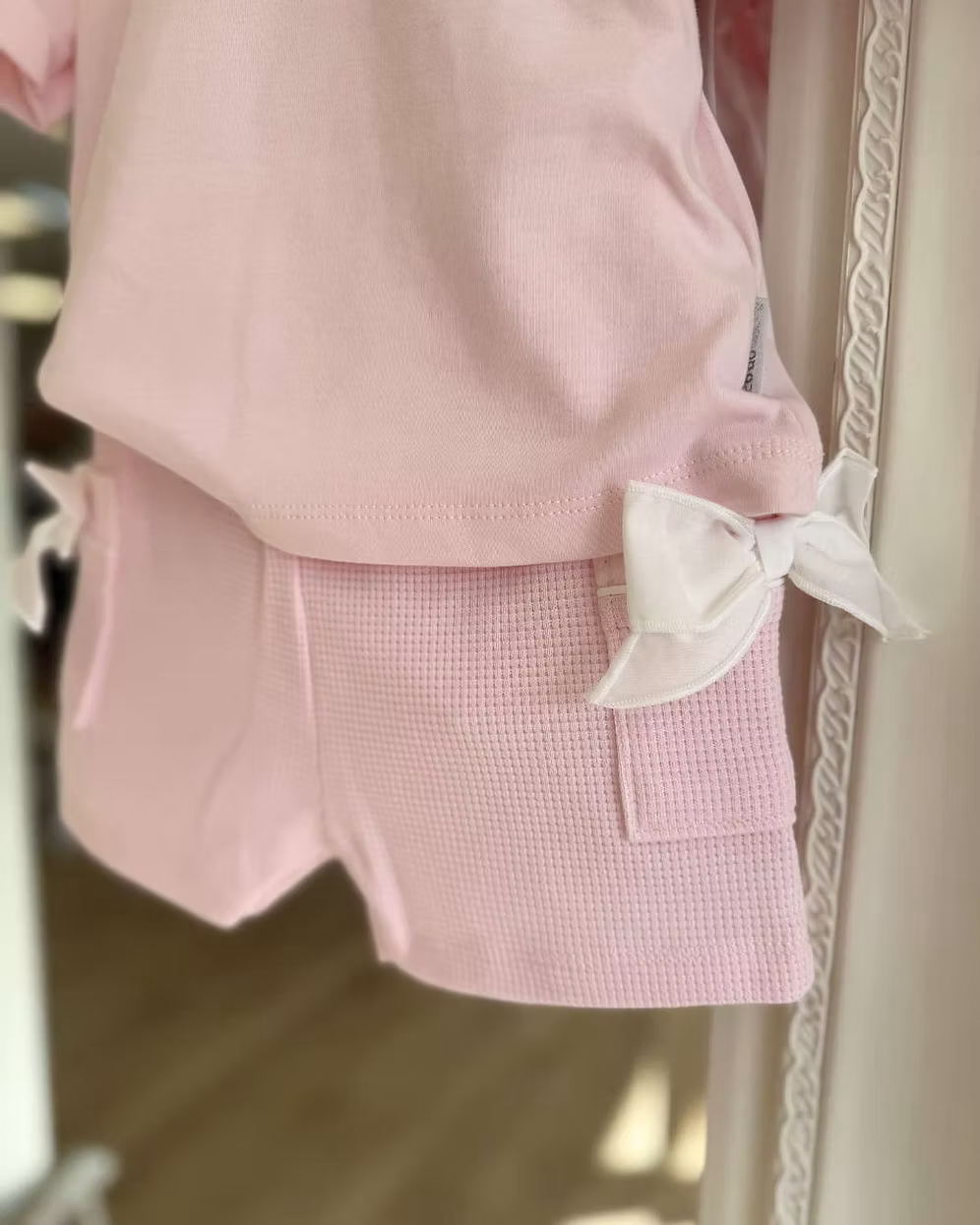 Bluesbaby Pia Pink Bow Short Set featuring a soft pink cotton top with puff sleeves, waffle shorts and contrasting white bow details.