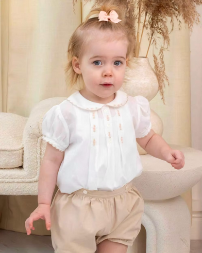 Sarah Louise x Little Lambs Heritage Girls Short Set featuring an ivory hand-smocked blouse with peach embroidery and neutral tailored shorts.