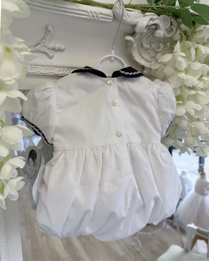back of the white bubble romper with button fastening