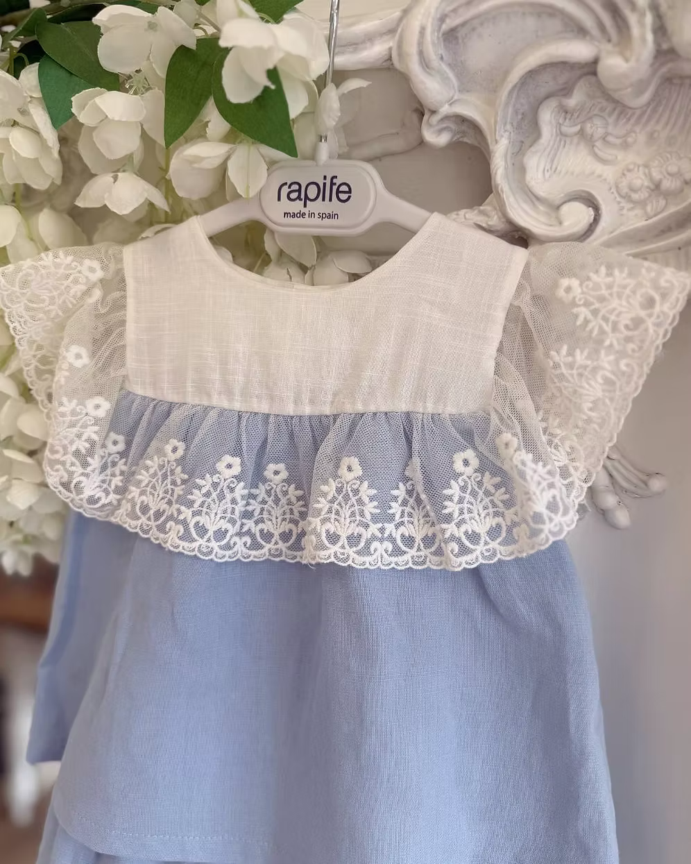 blue top and short with a white chest and white lace trim