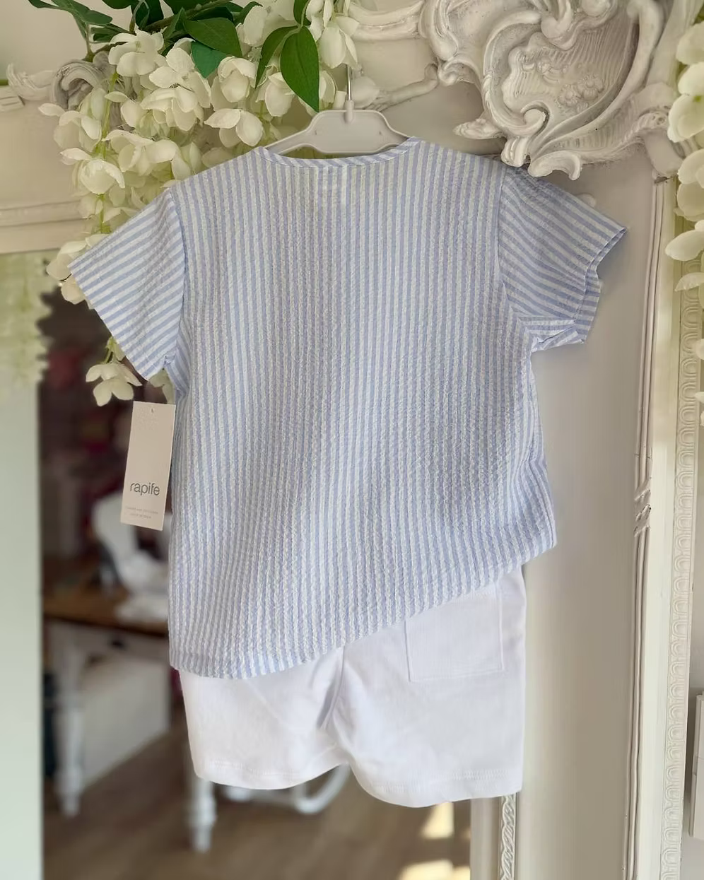 Blue and white striped shirt with white shorts