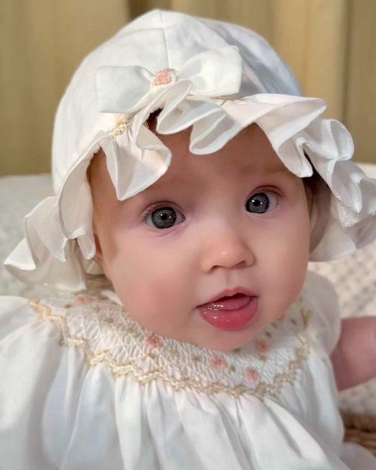 Sarah Louise x Little Lambs Heritage Ruffle Hat featuring soft ivory fabric, delicate ruffle trim and subtle embroidered detailing.