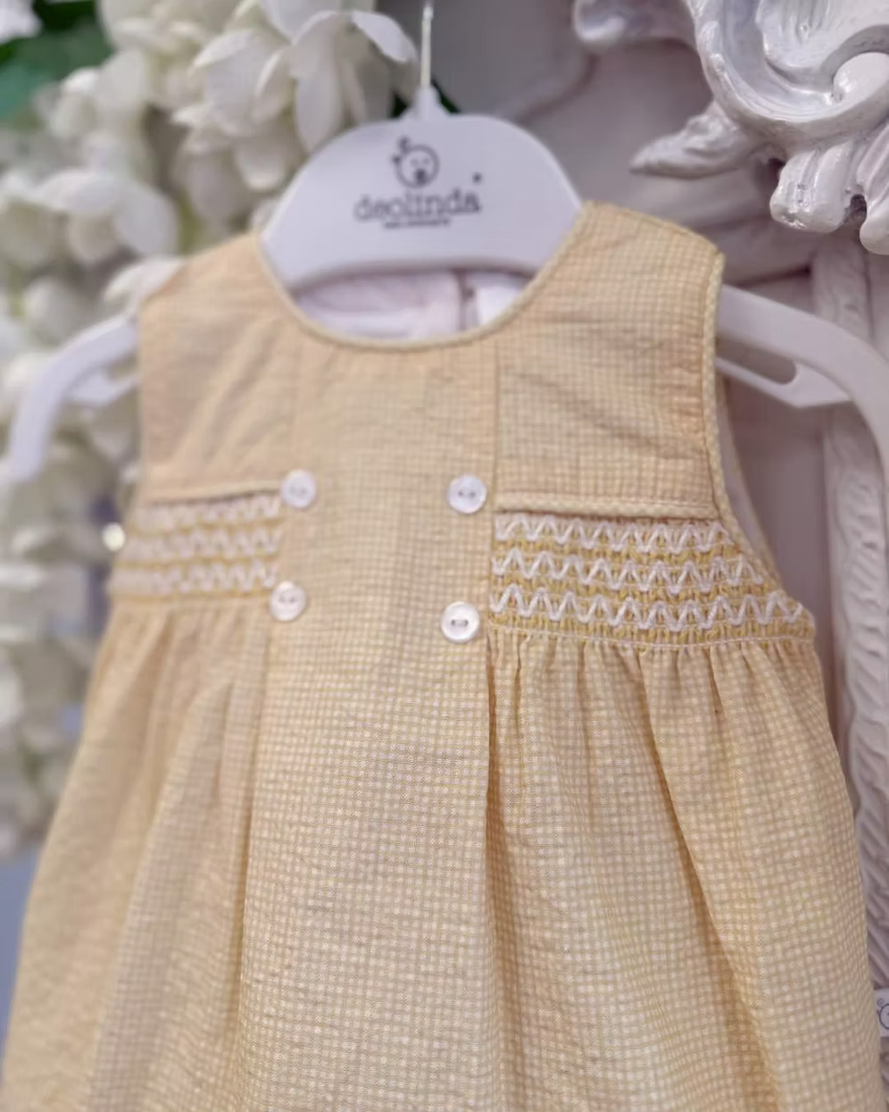 Deolinda Bumble Romper featuring buttery yellow gingham, a smocked chest panel, pleat detailing, button accents and a classic unisex design.