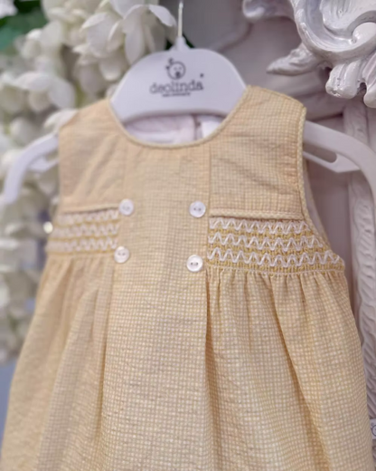 Deolinda Bumble Romper featuring buttery yellow gingham, a smocked chest panel, pleat detailing, button accents and a classic unisex design.