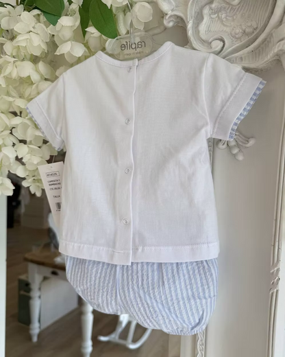 Children's white shirt with aback popper fastening and striped shorts hanging on a decorative mirror.