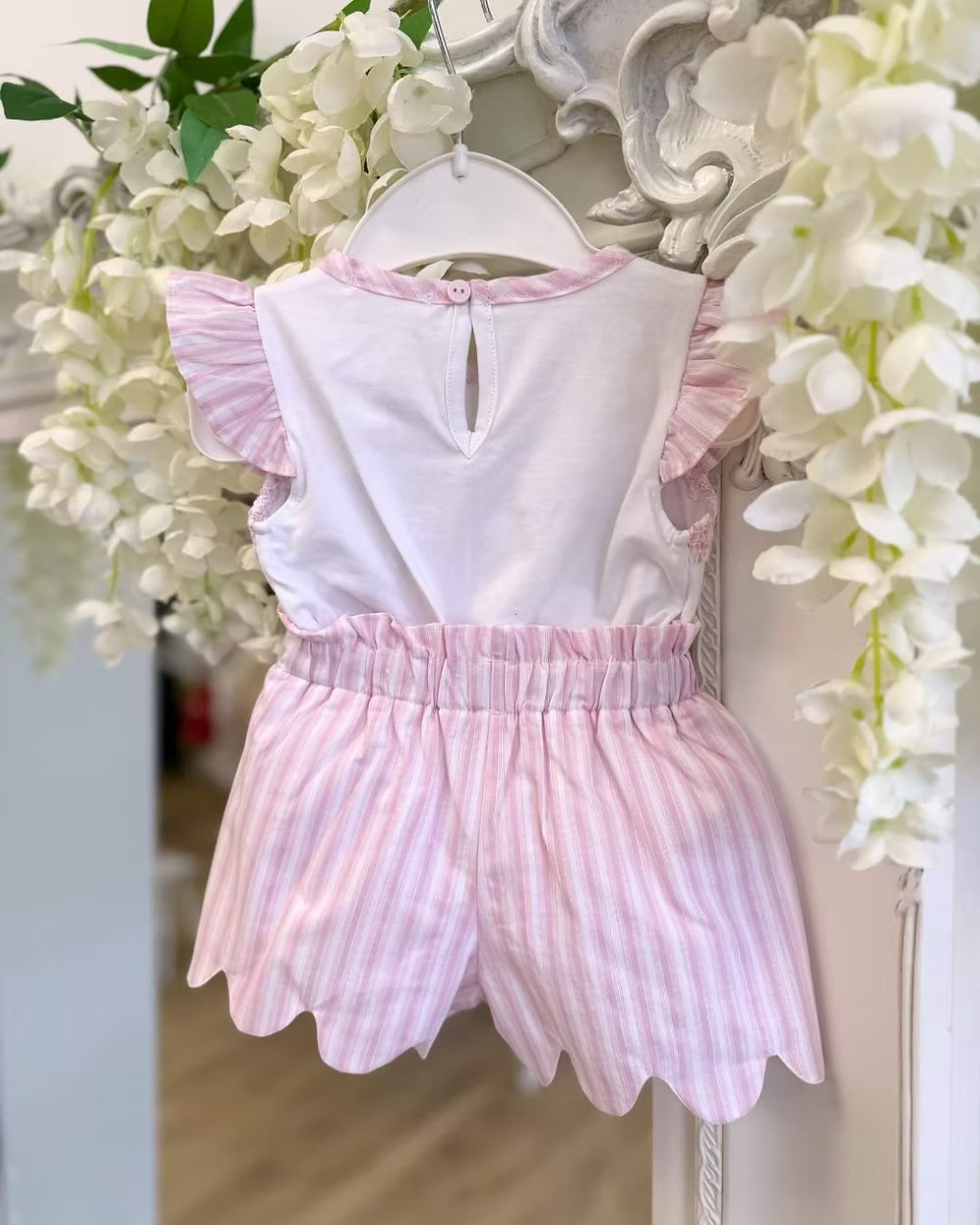 Deolinda California Pink Stripe Short Set featuring a white top with pink smocking, rosebud embroidery, bow detail and pink striped shorts.