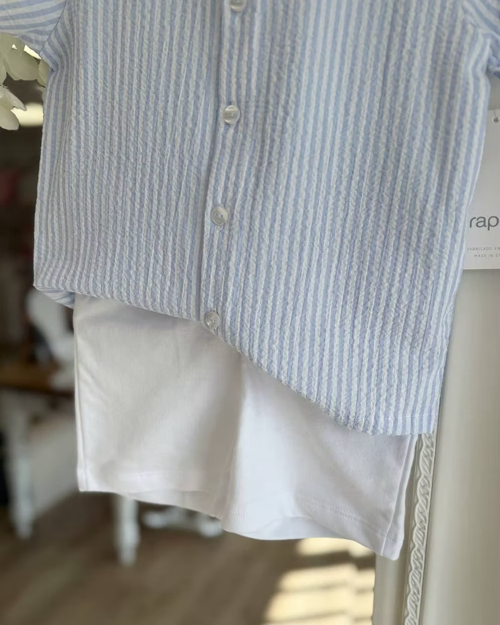 Blue and white striped shirt with white shorts