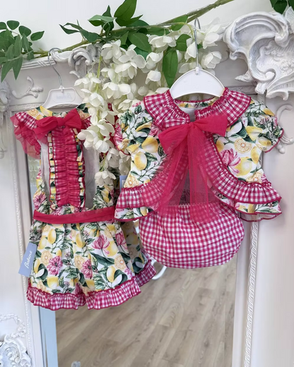 Babine Lemon Blossom Swing Back Dress & Pants featuring a lemon and pink floral print, open swing back, large tulle bow, frill collar, and matching pink gingham pants.