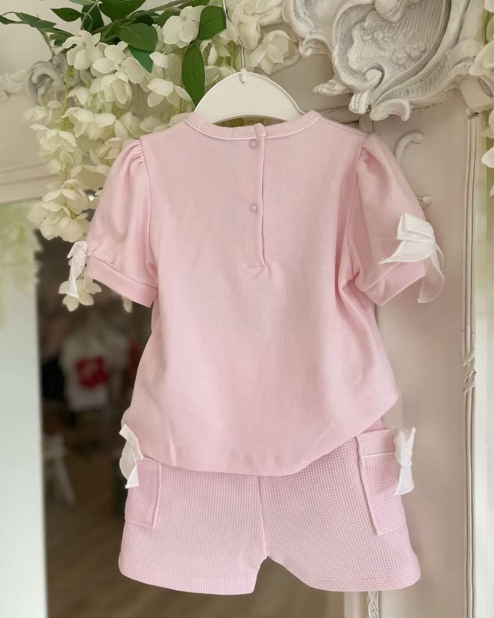 Bluesbaby Pia Pink Bow Short Set featuring a soft pink cotton top with puff sleeves, waffle shorts and contrasting white bow details.