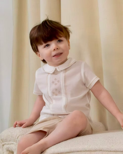 Sarah Louise x Little Lambs Heritage Boys Short Set featuring an ivory shirt with traditional detailing and tailored beige shorts.