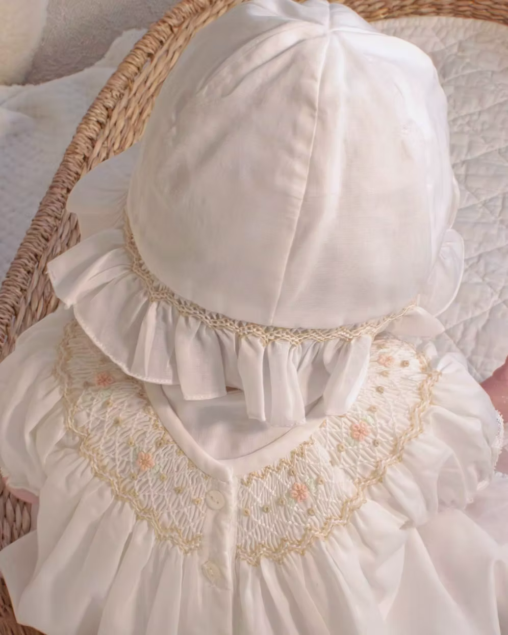 Sarah Louise x Little Lambs Heritage Bubble Romper featuring ivory fabric, hand-smocked floral embroidery, puff sleeves and a classic bubble shape.