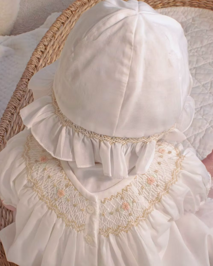 Sarah Louise x Little Lambs Heritage Bubble Romper featuring ivory fabric, hand-smocked floral embroidery, puff sleeves and a classic bubble shape.