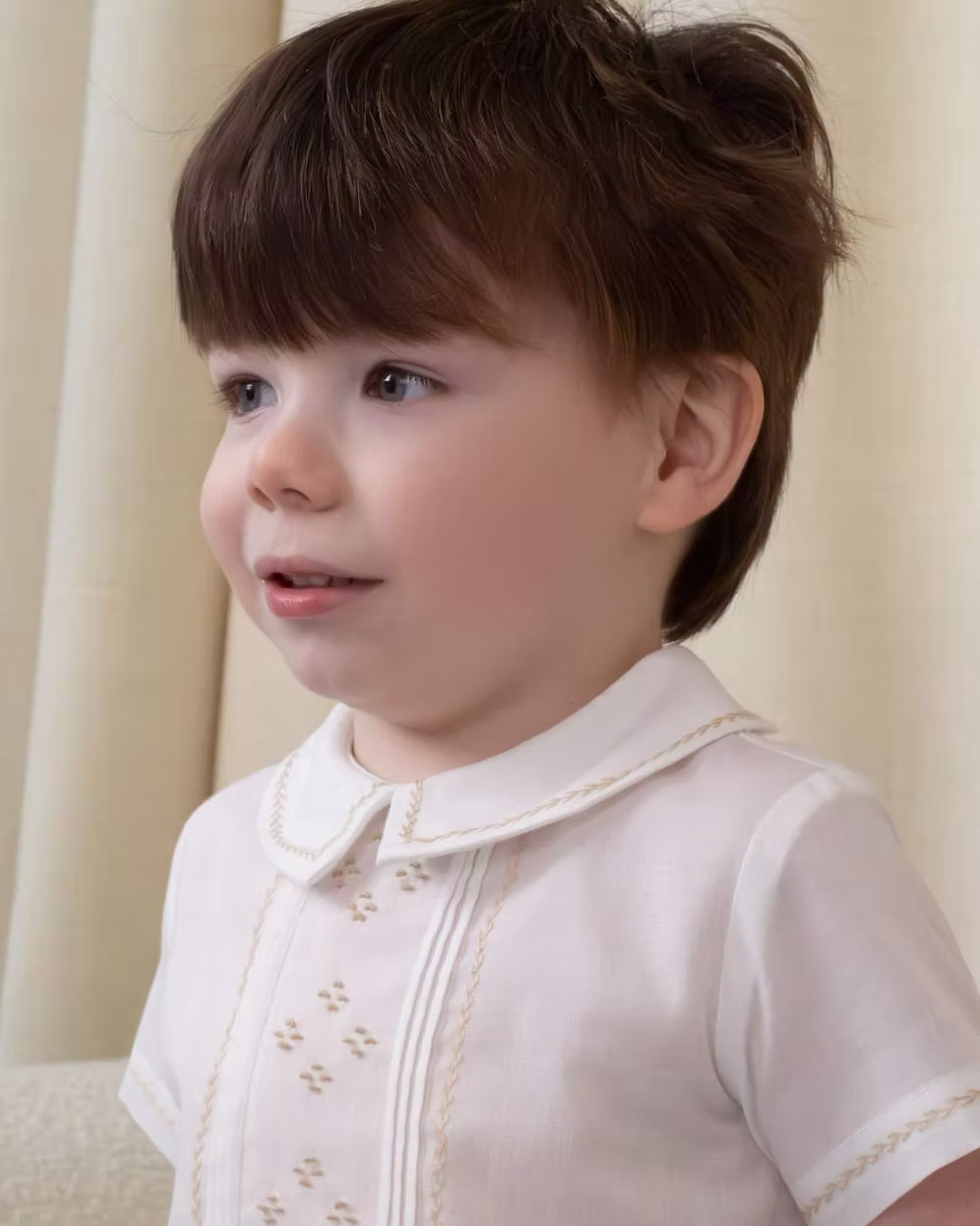 Sarah Louise x Little Lambs Heritage Boys Short Set featuring an ivory shirt with traditional detailing and tailored beige shorts.