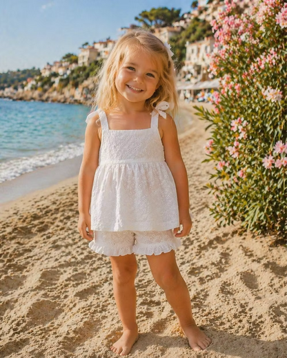 white broderie anglaise floaty top with matching frill trim shorts and shoulder ties